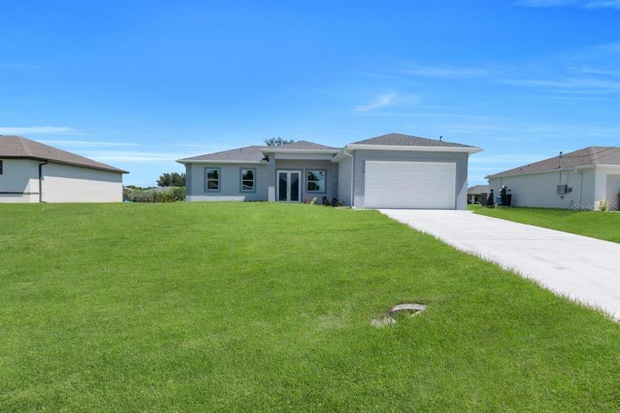 Front exterior of a new home in , Lehigh Acres, FL, highlighting curb appeal (Image 18). Front exterior of a new home in , Lehigh Acres, FL, highlighting curb appeal (Image 18).