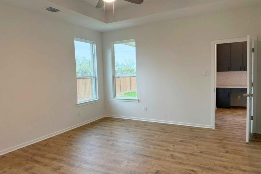 Unfurnished room with wood finished floors and a ceiling fan