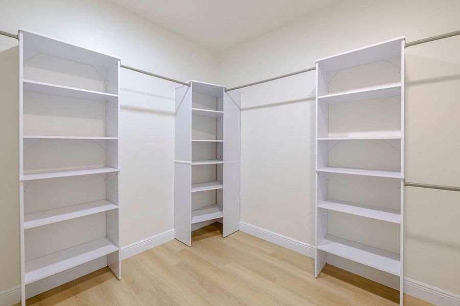 Very Large walk-in closet with ample shelves and storage.