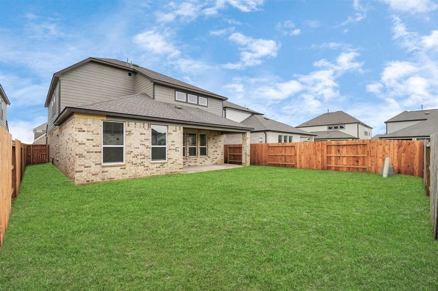 Explore the expansive backyard with its inviting covered patio—a perfect blend of space for the kids to play and adults to unwind.