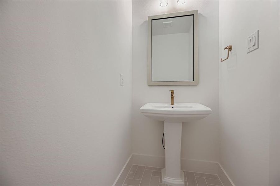 Bathroom featuring baseboards and tile patterned flooring Bathroom featuring baseboards and tile patterned flooring