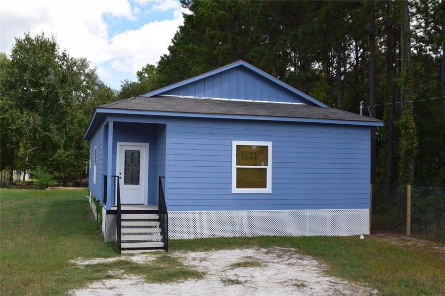 Front exterior of a new home in , Cleveland, TX, highlighting curb appeal (Image 13).