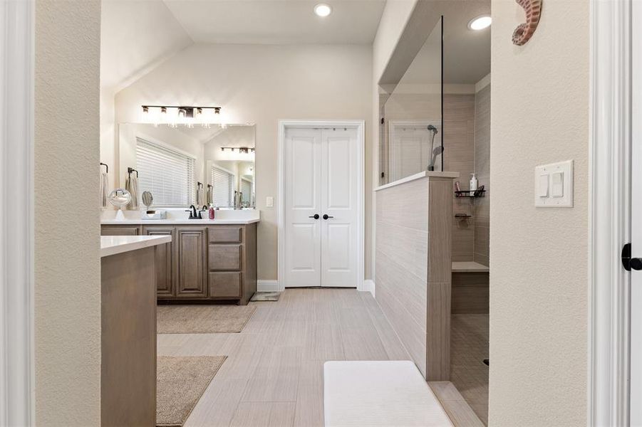 Contemporary bathroom featuring a large walk-in shower with a built-in bench, glass enclosure, and tiled walls Contemporary bathroom featuring a large walk-in shower with a built-in bench, glass enclosure, and tiled walls