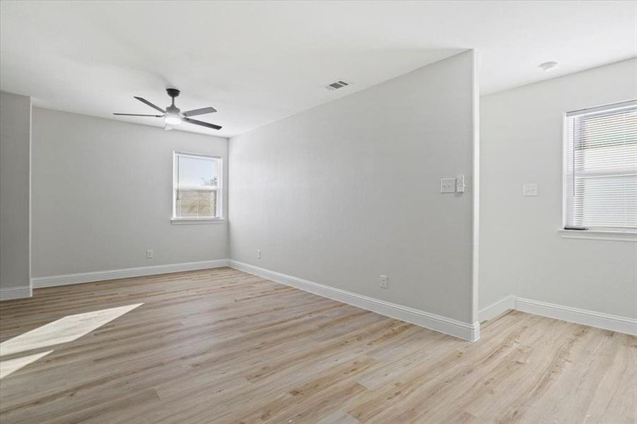 Spare room with light wood-type flooring and ceiling fan