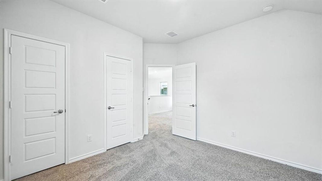 Unfurnished bedroom featuring carpet floors and baseboards