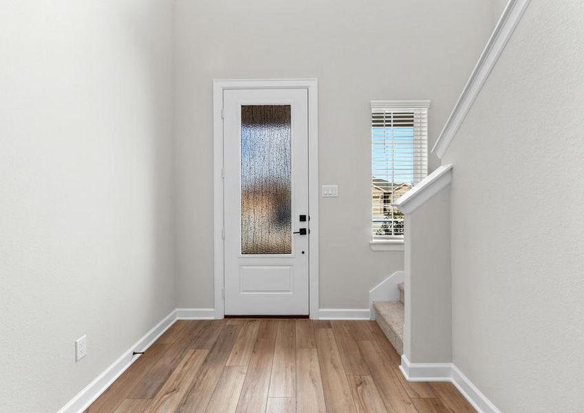 The entryway is highlighted by this gorgeous 3/4 lite door!