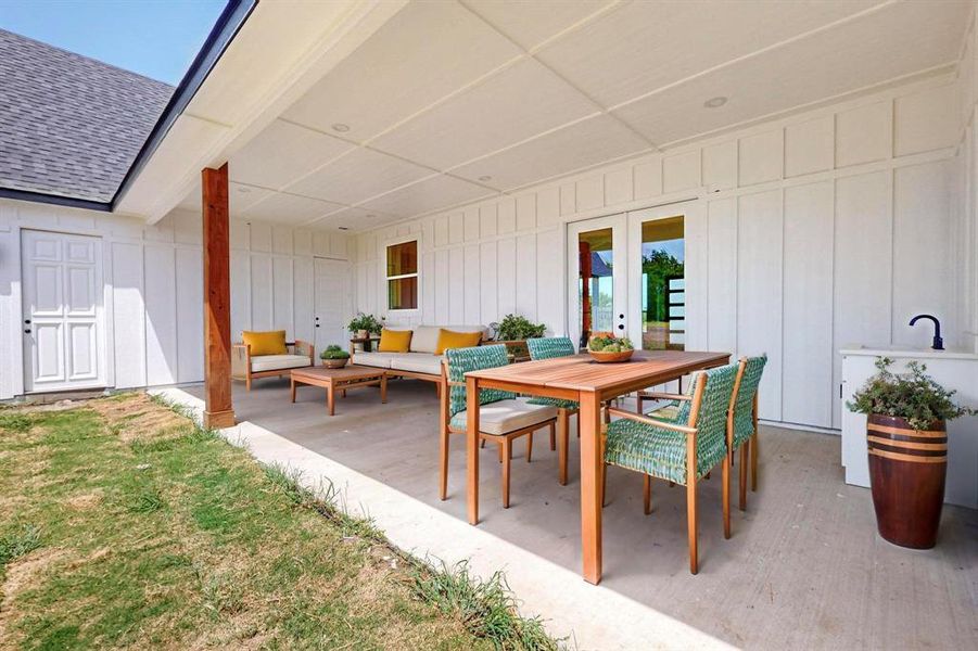 View of patio with an outdoor hangout area