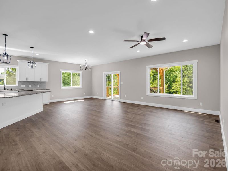 Open floor plan (kitchen, dining and living) hardwood floors, granite counters, sliders to covered screened porch Virtually Staged to allow buyers to envision the space Open floor plan (kitchen, dining and living) hardwood floors, granite counters, sliders to covered screened porch Virtually Staged to allow buyers to envision the space