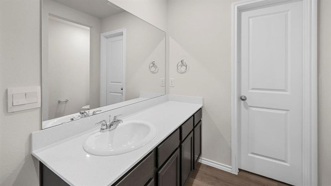 Bathroom with vanity and dark wood-style flooring