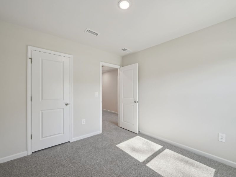 Two secondary bedrooms are ideally situated away from the primary suite.
