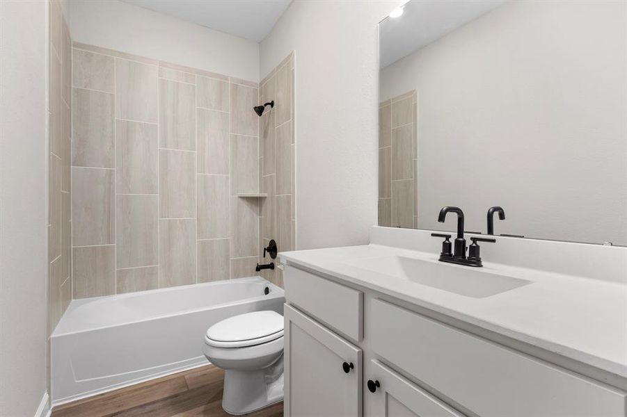 The secondary bathroom also has granite countertops and a beautiful backsplash in the shower.