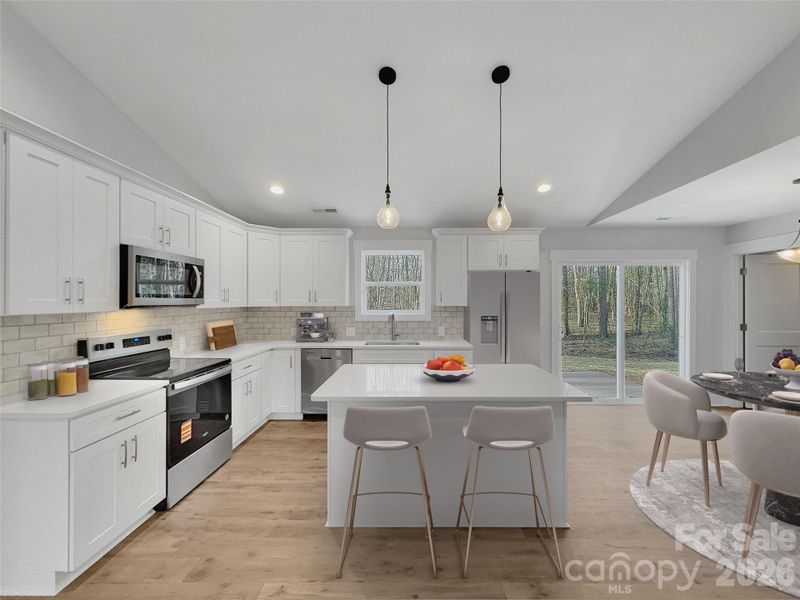 Beautiful Kitchen with white soft close cabinets, quartz counters, and tile backsplash*virtually staged Beautiful Kitchen with white soft close cabinets, quartz counters, and tile backsplash*virtually staged