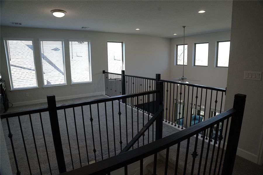 Hall featuring carpet, recessed lighting, and an upstairs landing Hall featuring carpet, recessed lighting, and an upstairs landing