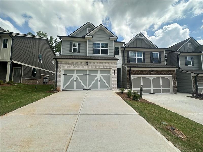 Front exterior of a new home in , Flowery Branch, GA, highlighting curb appeal (Image 11).