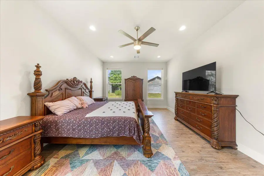 Bedroom with light wood-style floors, a ceiling fan, and recessed lighting Bedroom with light wood-style floors, a ceiling fan, and recessed lighting
