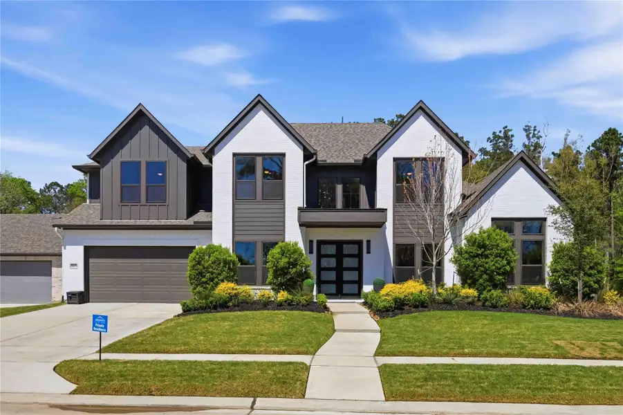 Front exterior of a new home in Artavia, Conroe, TX, highlighting curb appeal (Image 23).