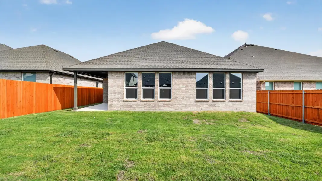 Exterior details and patio area of a home in Bluestem, Rhome (Image 16).