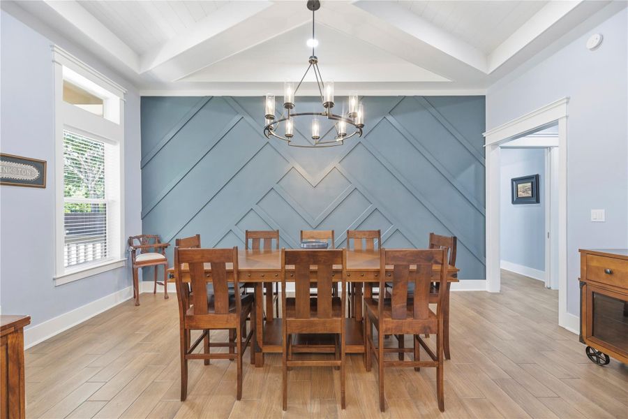 Architecturally striking dining space enhanced by dramatic ceiling lines, designer lighting, and statement wall detailing.