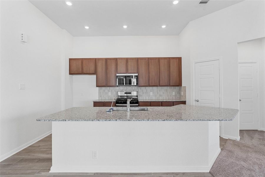This spacious kitchen has it all—ample storage, generous counter space, and a layout that truly makes it the heart of the home.