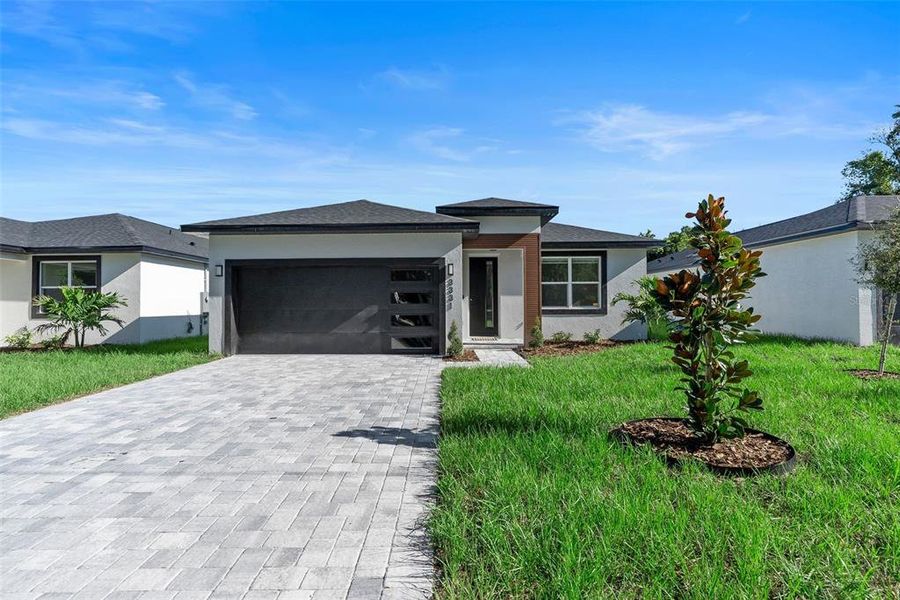 Front exterior of a new home in , Orlando, FL, highlighting curb appeal (Image 1).