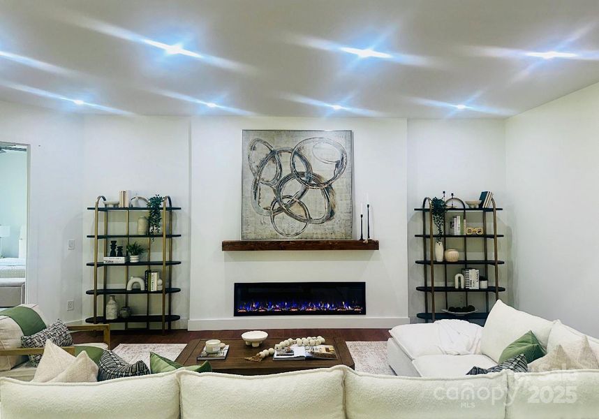 Living area to get warm and cozy with electric fireplace and recessed lighting.