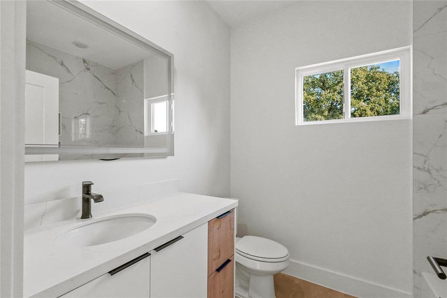 Bathroom featuring vanity and toilet