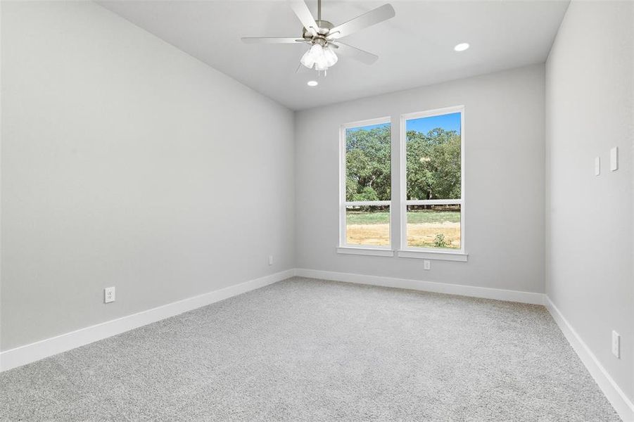 Empty room featuring light colored carpet, recessed lighting, and ceiling fan Empty room featuring light colored carpet, recessed lighting, and ceiling fan