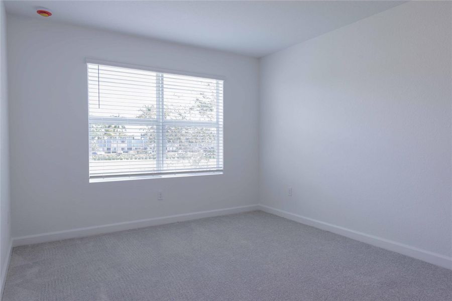 The primary bedroom has a double-sized window. All of the windows are impact glass.