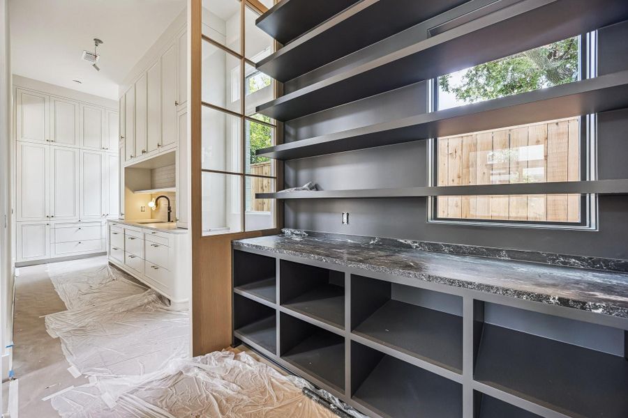 An amazing Pantry with open shelving, slab quarzite counter, large window and more....