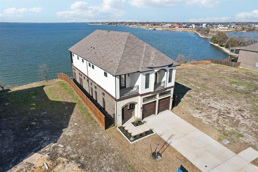 Located on the edge of Travis Ranch Marina overlooking neighboring Heath Golf & Yacht sharing exquisite Lake Ray Hubbard views.