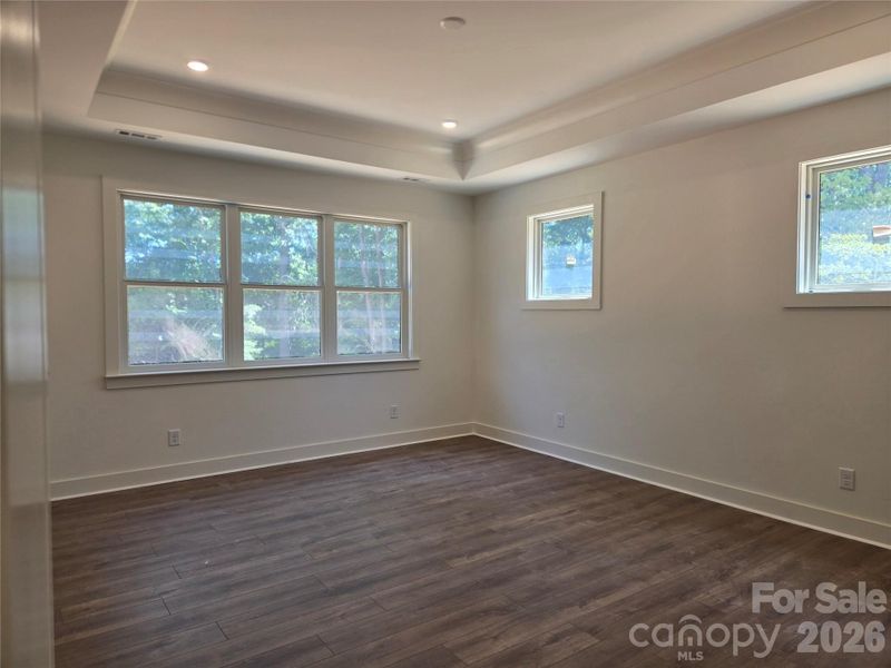 1st floor primary bedroom with trey ceiling and ensuite bathroom. 1st floor primary bedroom with trey ceiling and ensuite bathroom.