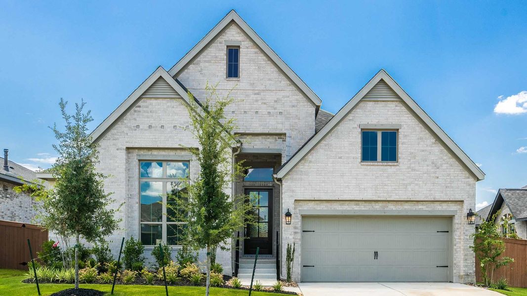 View of front facade featuring brick siding and driveway View of front facade featuring brick siding and driveway
