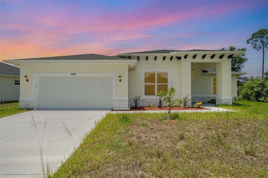 Front exterior of a new home in , Palm Bay, FL, highlighting curb appeal (Image 1). Front exterior of a new home in , Palm Bay, FL, highlighting curb appeal (Image 1).