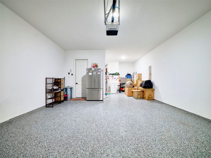 Oversized epoxy-finished garage wit space for storage, gym, or workshop. Oversized epoxy-finished garage wit space for storage, gym, or workshop.