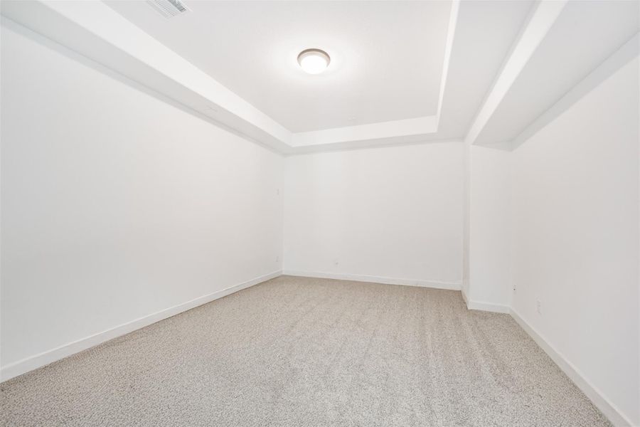 A theater room featuring an elegant coffered ceiling. A theater room featuring an elegant coffered ceiling.