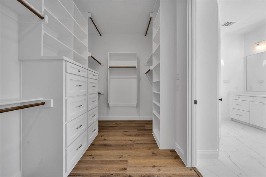 Walk in closet featuring light wood-style flooring