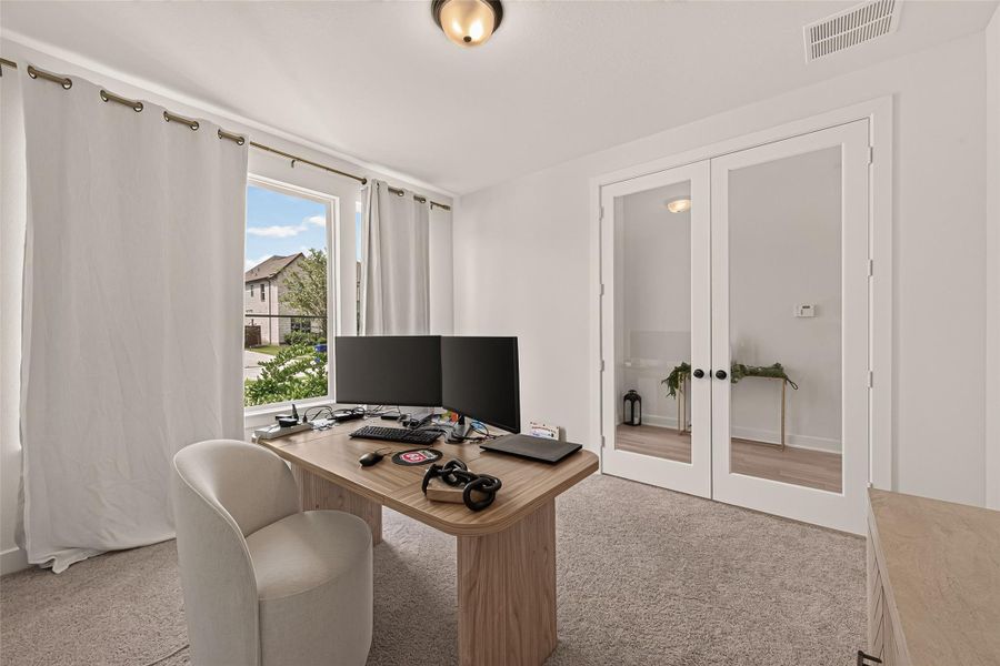 French doors provide privacy while allowing natural light to fill the home office. French doors provide privacy while allowing natural light to fill the home office.