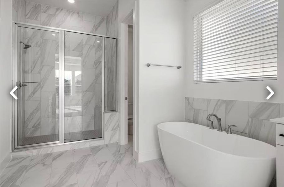 Full bathroom with light marble finish flooring, a marble finish shower, and a soaking tub