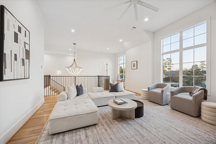 Generous proportions and high ceilings allow the game room to function as a comfortable lounge, media space, or secondary family room. Large windows bring in natural light, while the open connection to the upstairs landing keeps the space feeling social rather than isolated. Generous proportions and high ceilings allow the game room to function as a comfortable lounge, media space, or secondary family room. Large windows bring in natural light, while the open connection to the upstairs landing keeps the space feeling social rather than isolated.