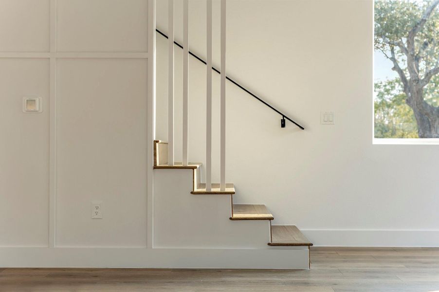 Staircase featuring board and batten accent wall Staircase featuring board and batten accent wall