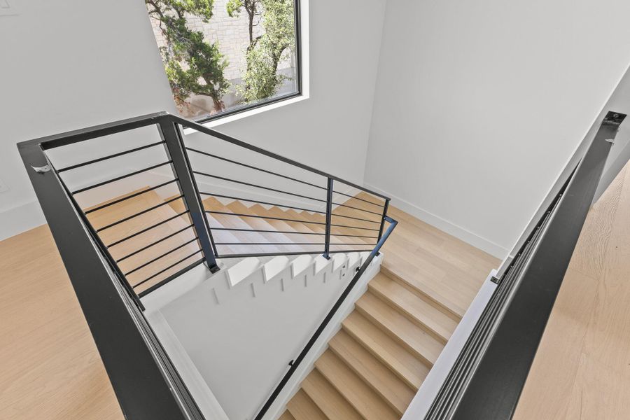 Clean lines define this striking modern staircase with light wood treads and contemporary metal railings. Clean lines define this striking modern staircase with light wood treads and contemporary metal railings.