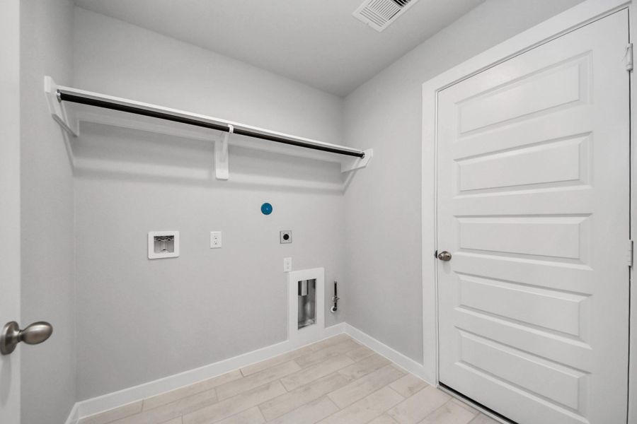 A perfect blend of functionality and comfort. Capture the essence of easy living with a first-floor laundry room, thoughtfully equipped with shelving for effortless organization. Both electric and gas connections available.