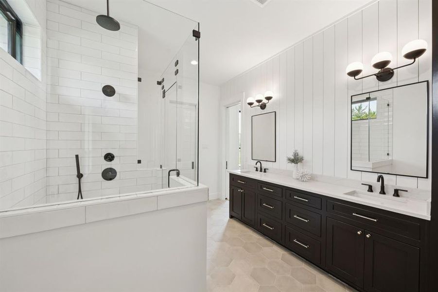 This Jack and Jill bath features dual sinks and a large walk-in shower. This Jack and Jill bath features dual sinks and a large walk-in shower.