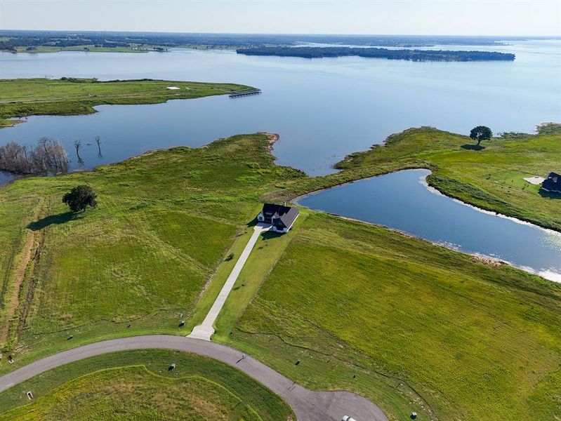 Aerial view of property and surrounding area with a nearby body of water Aerial view of property and surrounding area with a nearby body of water