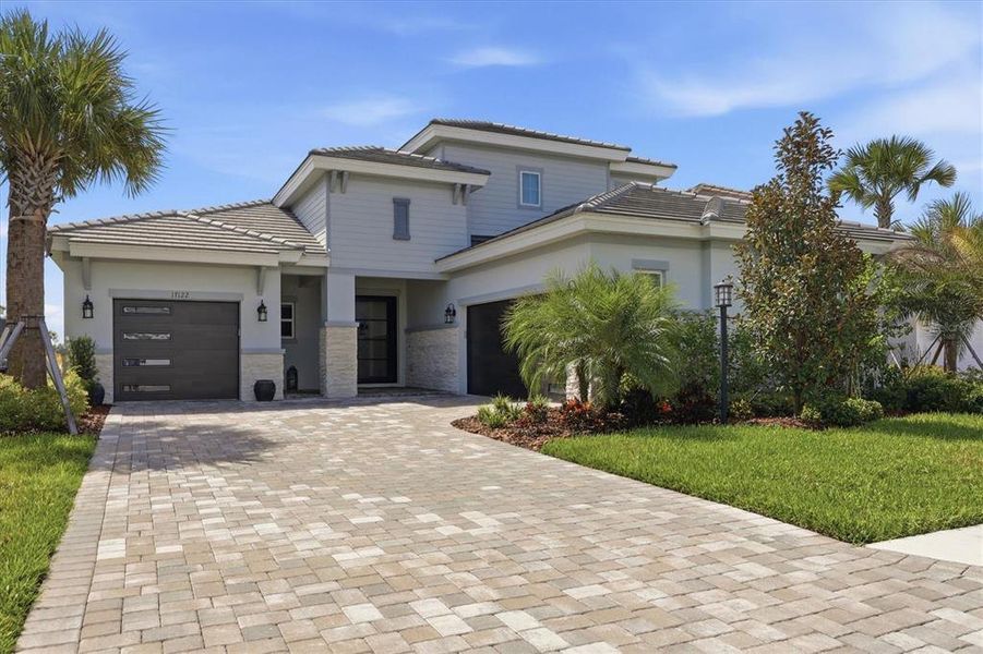 Front exterior of a new home in Star Farms at Lakewood Ranch, Lakewood Ranch, FL, highlighting curb appeal (Image 2). Front exterior of a new home in Star Farms at Lakewood Ranch, Lakewood Ranch, FL, highlighting curb appeal (Image 2).