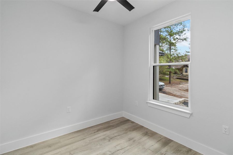 Unfurnished room with light wood-style flooring and a ceiling fan