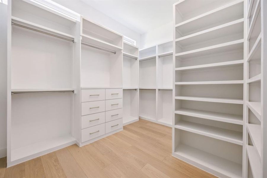 Spacious walk in closet to primary bedroom with high end finish outs. Spacious walk in closet to primary bedroom with high end finish outs.