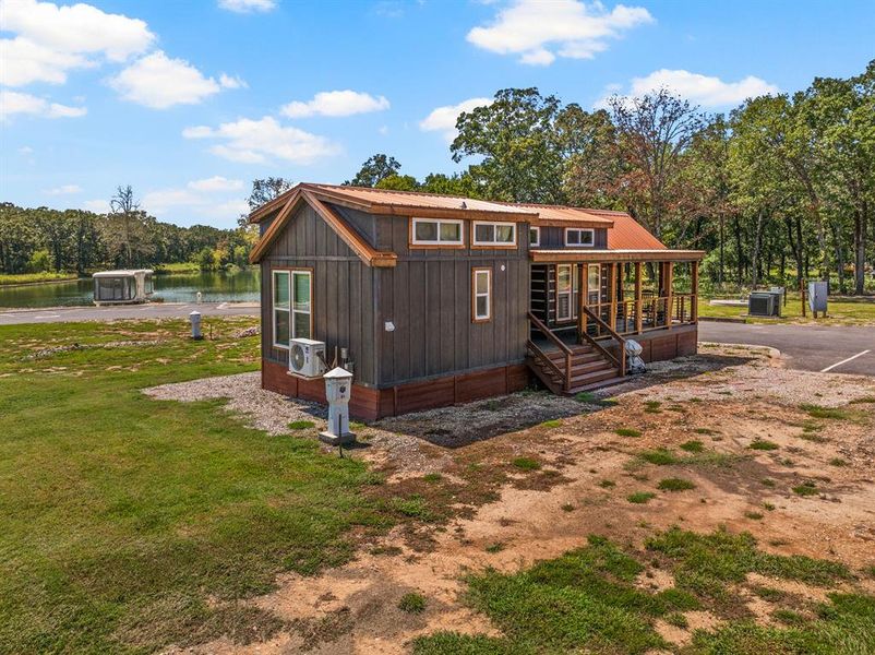 Chalet / cabin with a metal roof and a water view