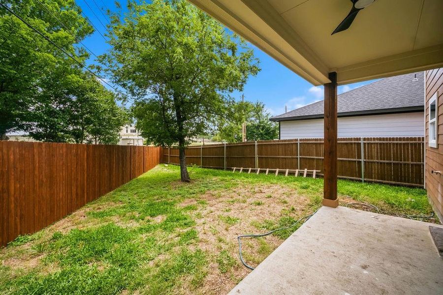 Covered patio with an outdoor ceiling fan, concrete flooring, and a wood support column Covered patio with an outdoor ceiling fan, concrete flooring, and a wood support column