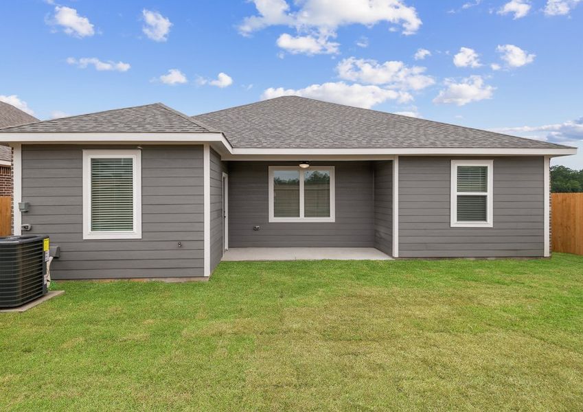 A backyard with a covered patio and landscaping A backyard with a covered patio and landscaping